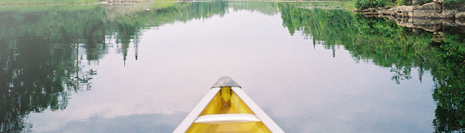Serene northern lake with yellow canoe